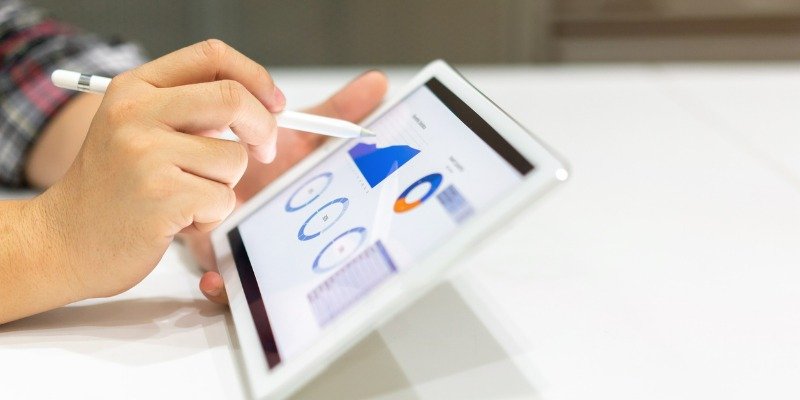 close up businessman hand using stylus pen on screen dashboard of graph and chart statistics data for analyzing about profit monthly, business and financial concept.