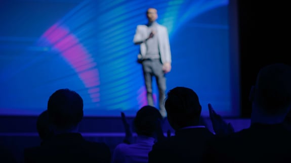 A man on stage at a conference