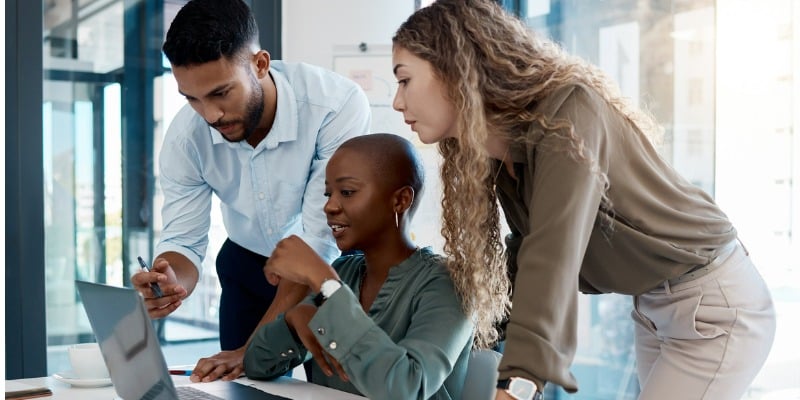 Group of coworkers looking at a screen.